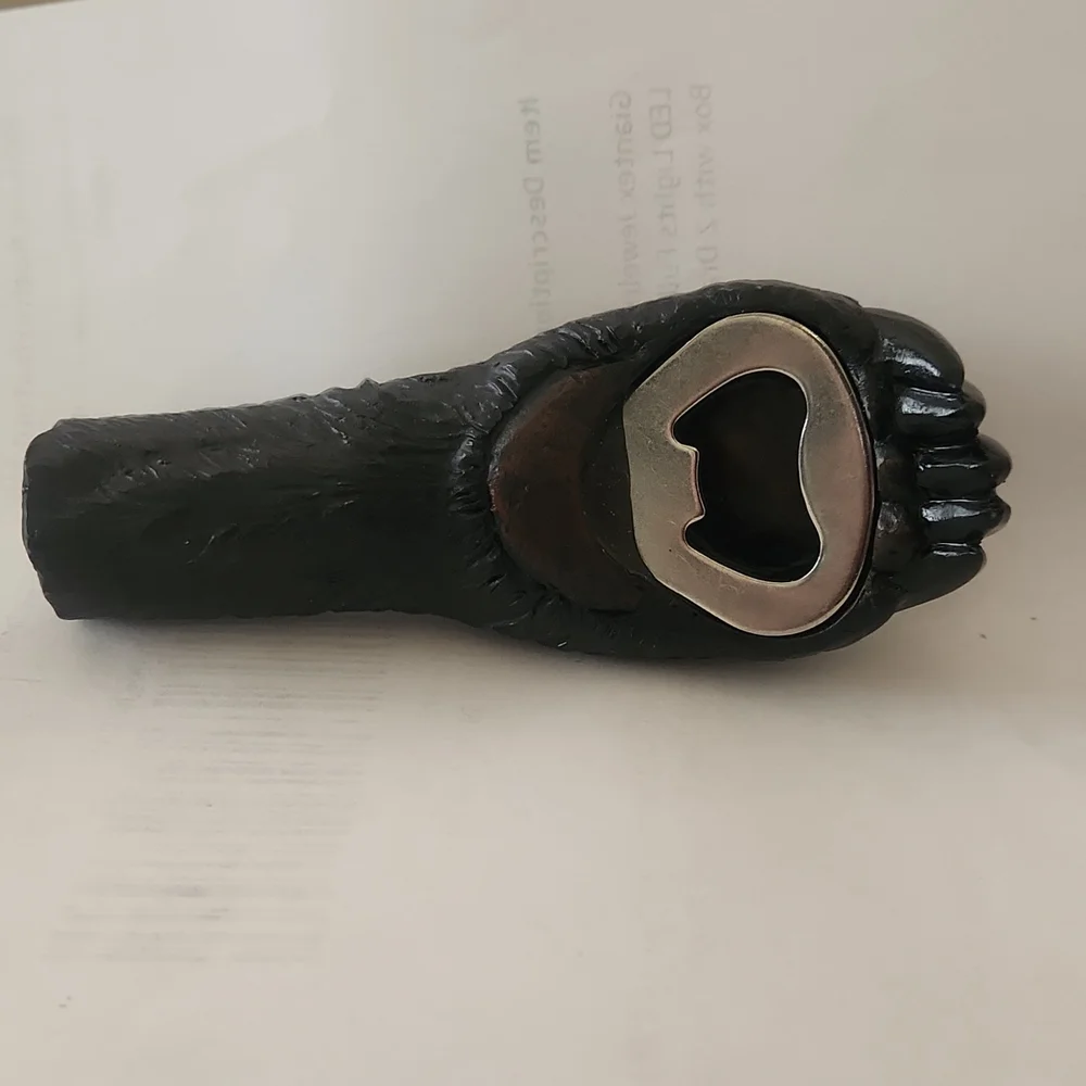 RESIN AND METAL BEAR PAW BOTTLE OPENER.